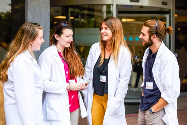 Students chatting outside a hospital.