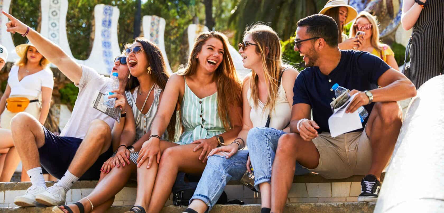 Students sitting on a set of stairs enjoying the atmosphere.