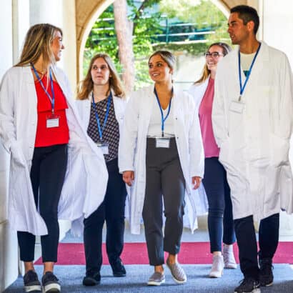 Students walking through the hallway of the hospital where they are shadowing.