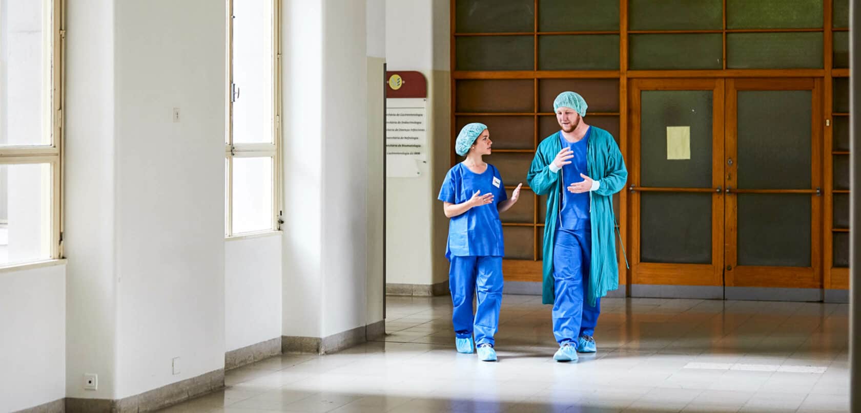 Students walking through a hospital hallway.
