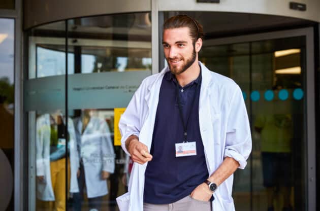 A student standing outside a hospital.