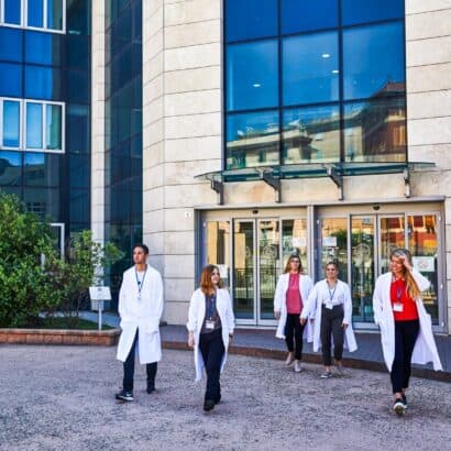 Students walking out of the entrance of the hospital.